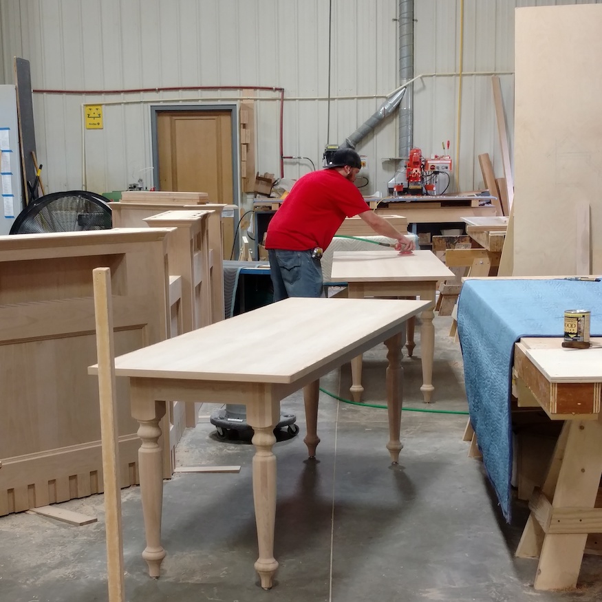 sanding millwork in our shell lake woodworking shop