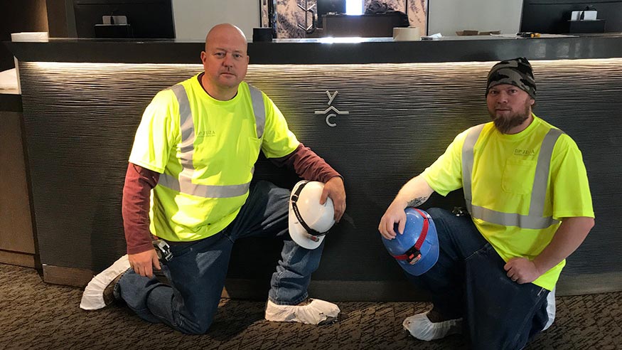 Two of our craftsmen take a knee in front a job well done.