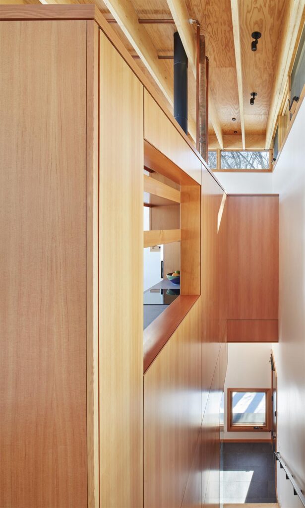 The custom residential woodworking paneling along the stairwell in the Nordlys Lodging MetalLark tower